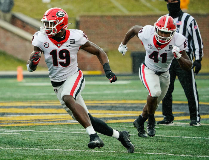 Dec 12, 2020; Columbia, Missouri, USA; Georgia Bulldogs linebacker Adam Anderson (19) and linebacker Channing Tindall (41) defend against the Missouri Tigers during the second half at Faurot Field at Memorial Stadium.